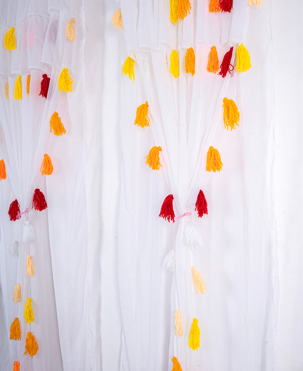 White Sheer Curtain with Yellow and Red Tassel Design
