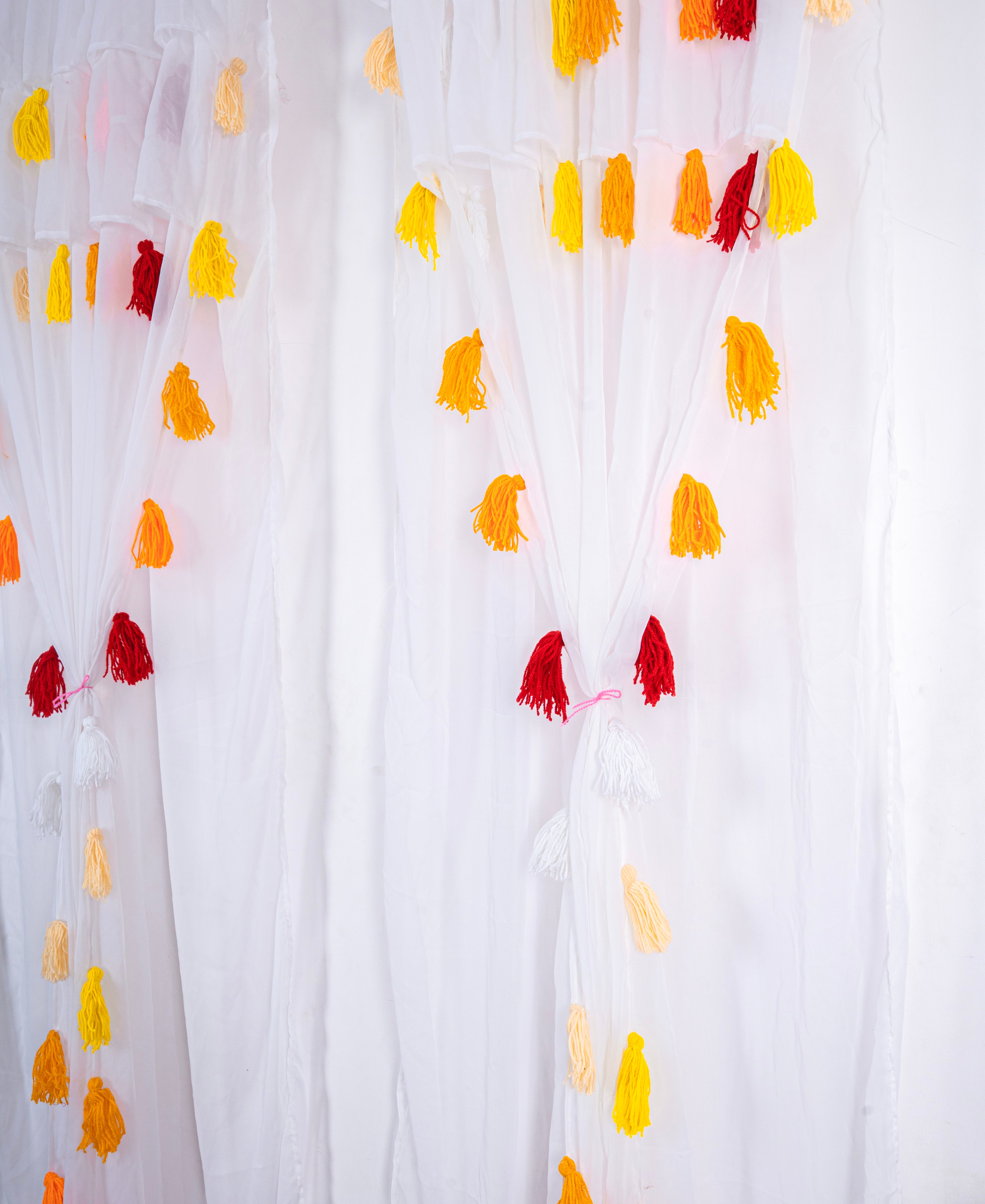 White Sheer Curtain with Yellow and Red Tassel Design