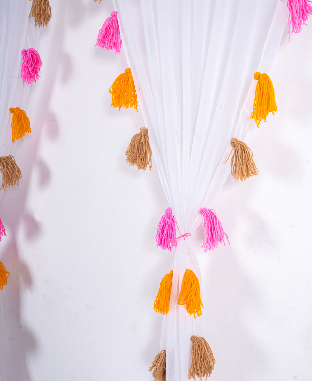 White Sheer Curtain with Pink, Orange, and Brown Tassel Rows