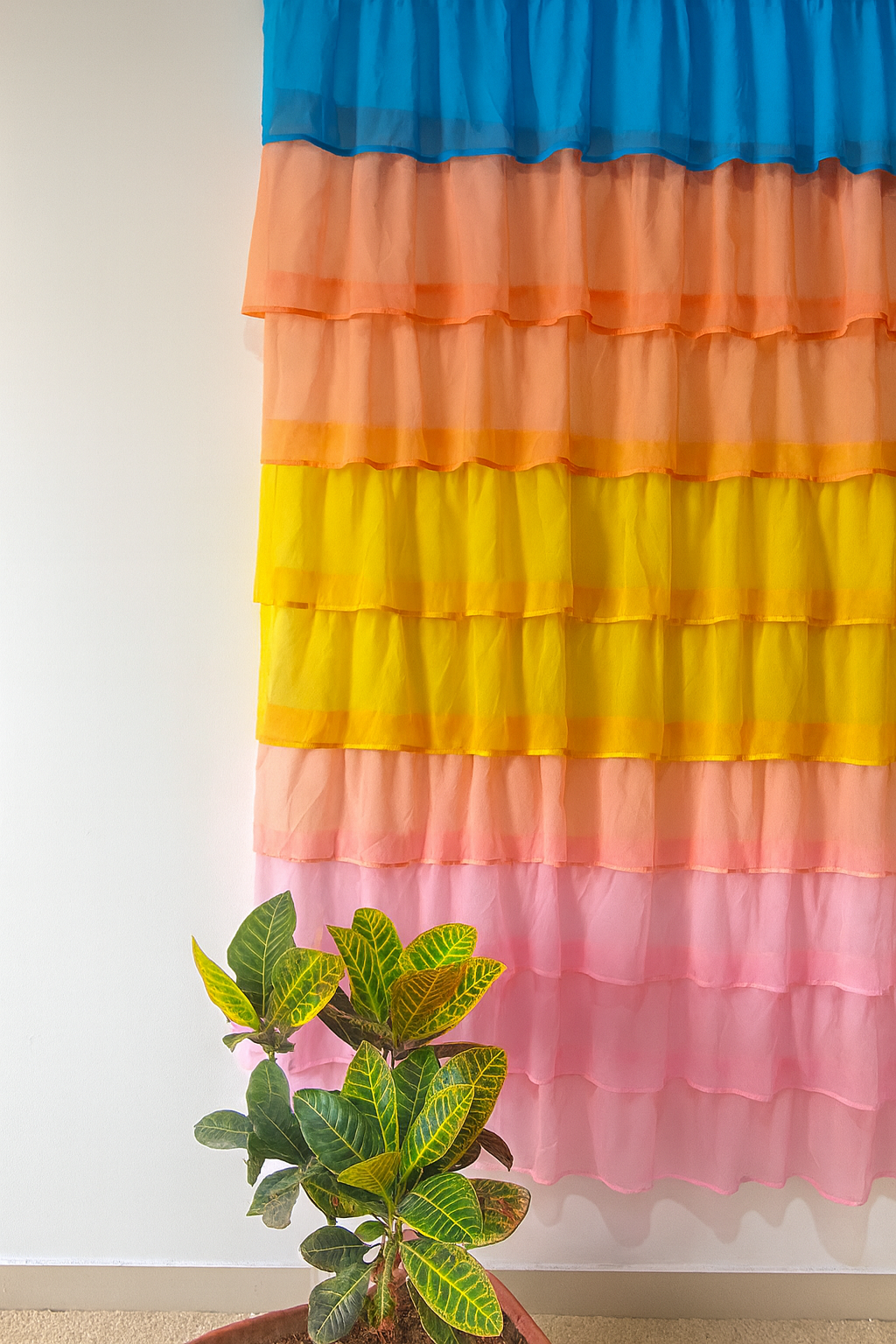Multi-Color Layered Curtains with Blue, Yellow, Orange, and Pink Tones